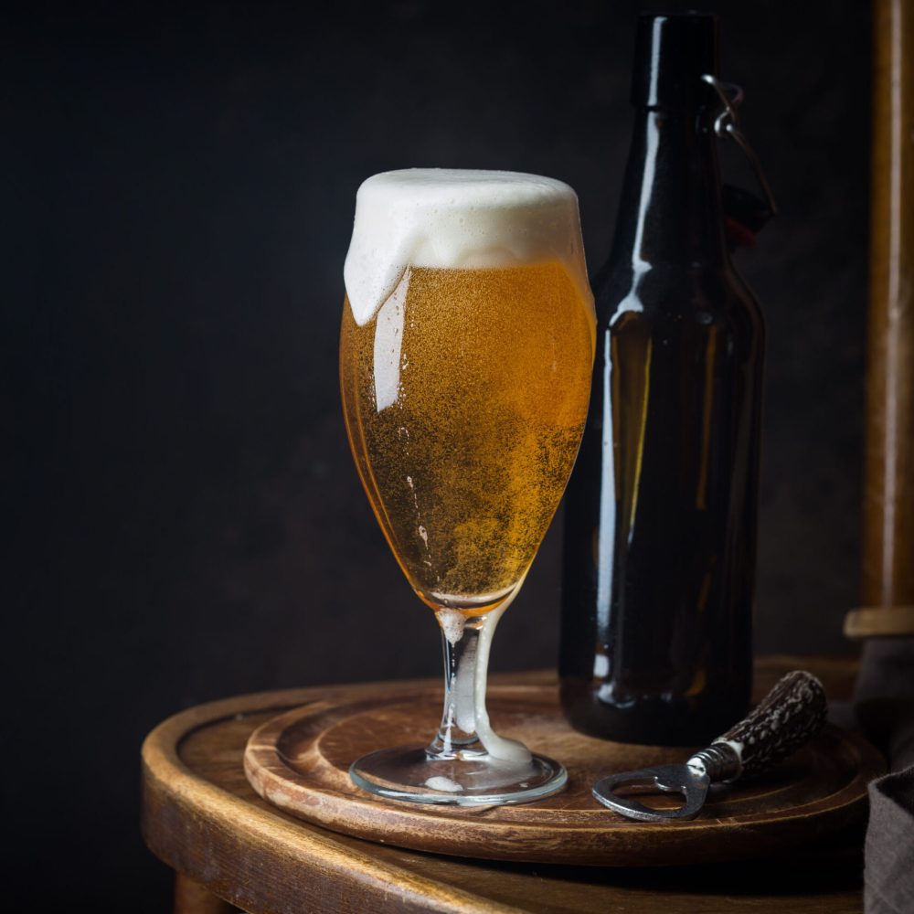 Glass beer on dark background with copy space