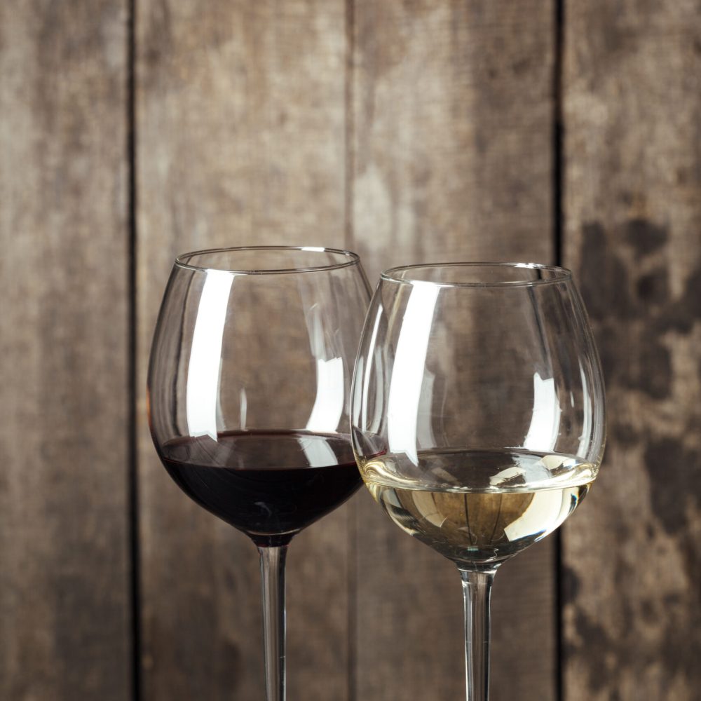 Glass of Wine on The Wooden Table. creative photo.